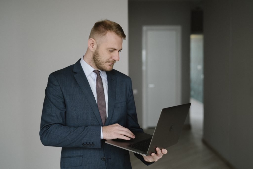 Image of an house Appraiser walking through a home with a laptop, Blog image
